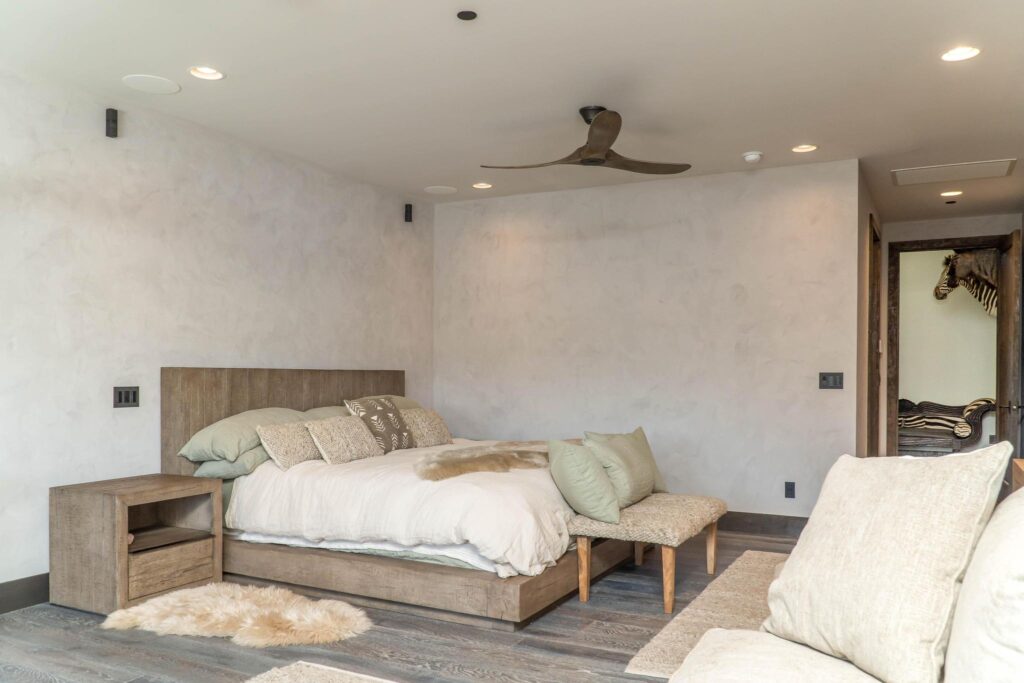 Bedroom with a timber headboard and a bench at the foot of the bed