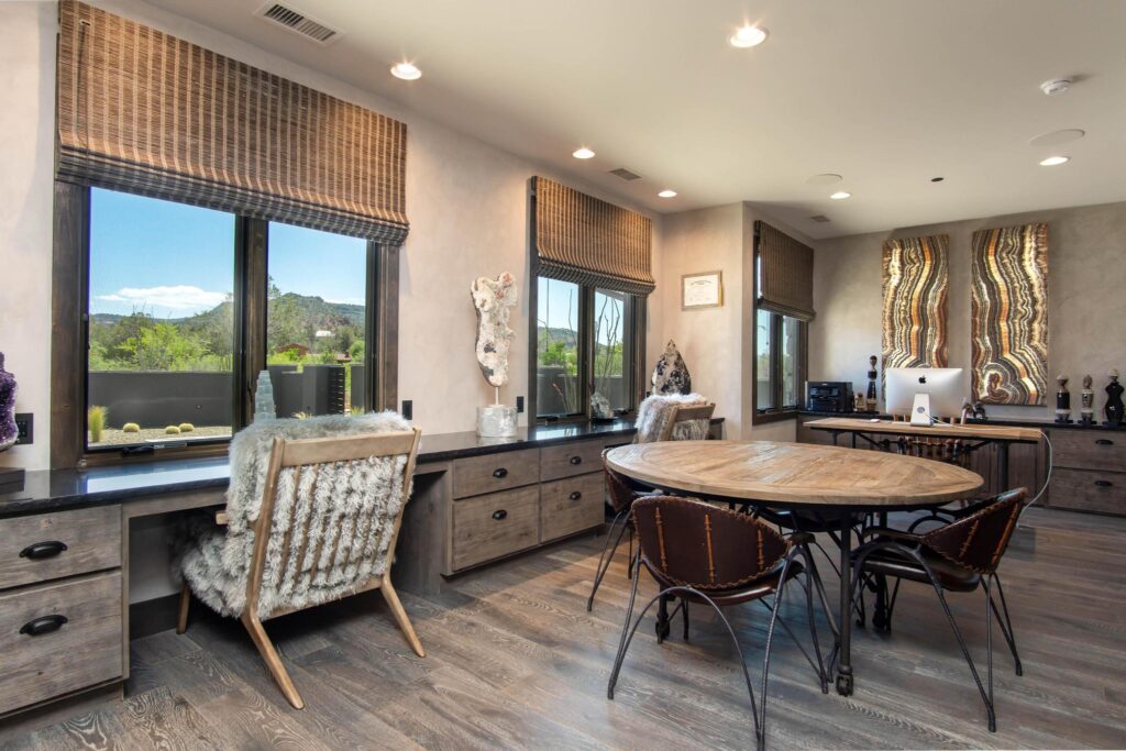 Study with a built-in desk along the windows and a round table