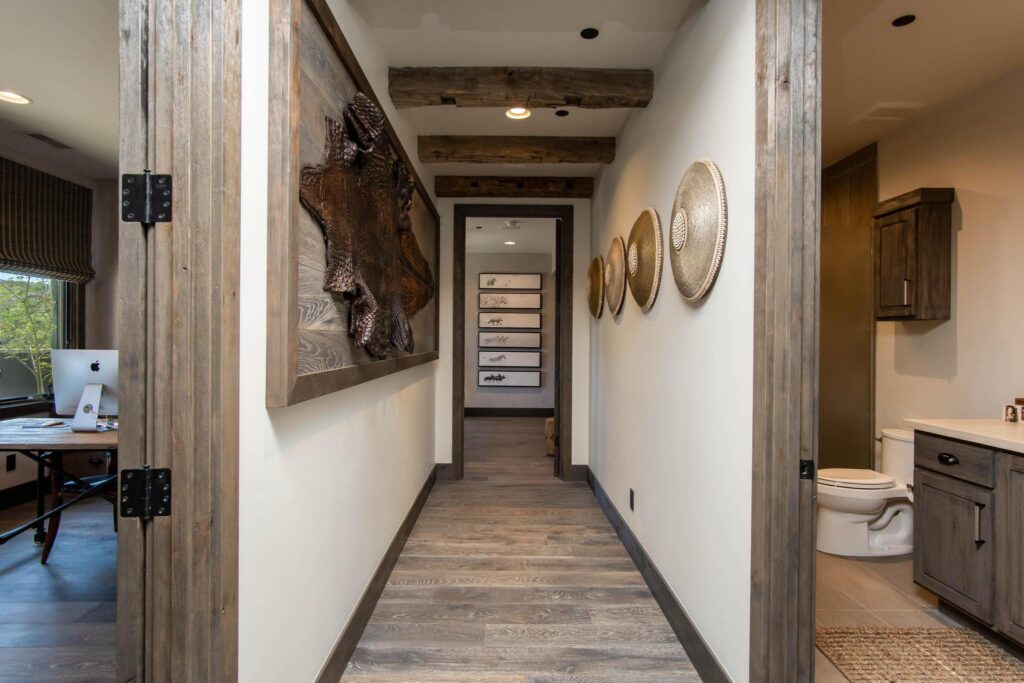 Passage between the study and the bedrooms, hung with carved and woven pieces
