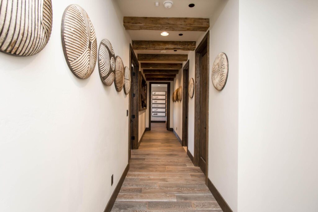 Hallway lined with woven baskets under a timber beam