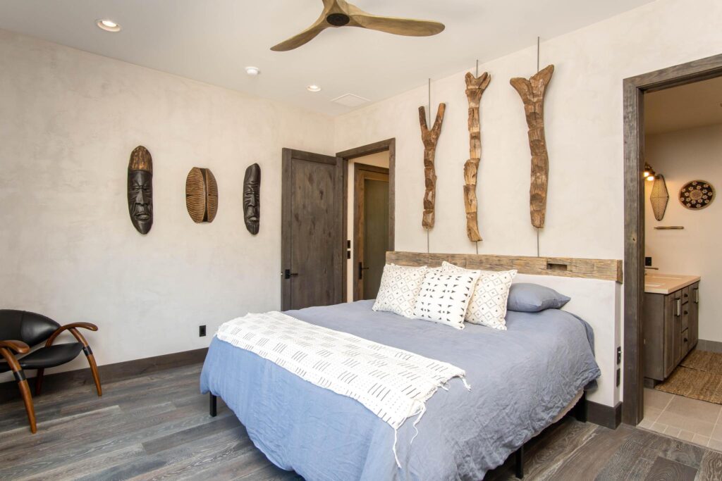 Bedroom with carved figures mounted above the headboard