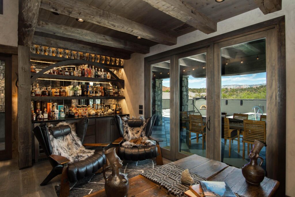 Bar with bottles racked to the ceiling, opening onto the terrace