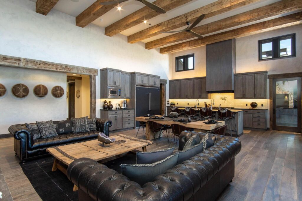 The same room from the kitchen end, clerestory windows above the beams