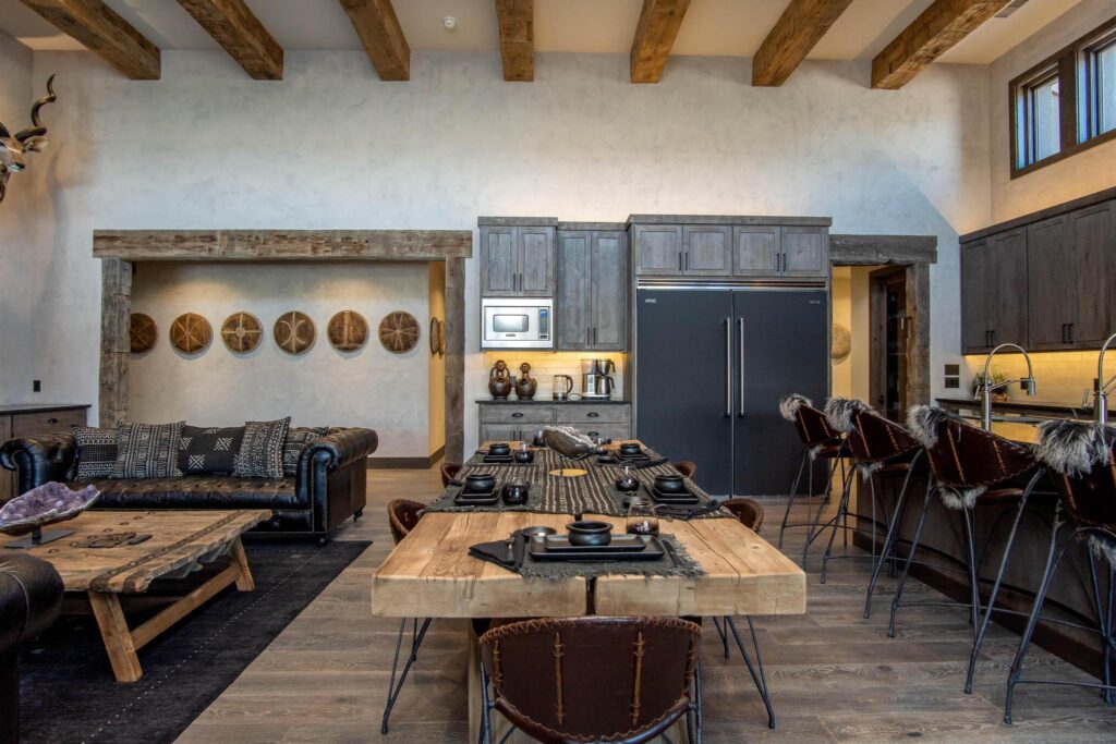 Dining and living space under hewn beams, woven discs on the wall