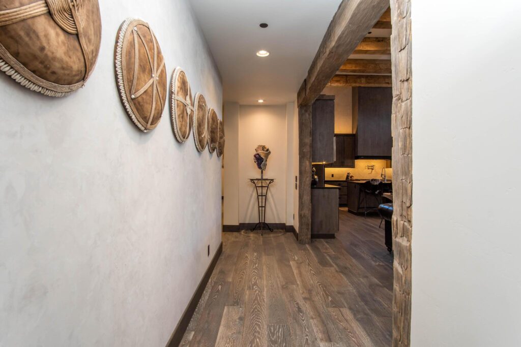 Hallway hung with woven baskets, leading through to the kitchen