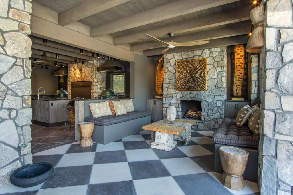 The pavilion fireplace and outdoor kitchen, carved panel above the hearth