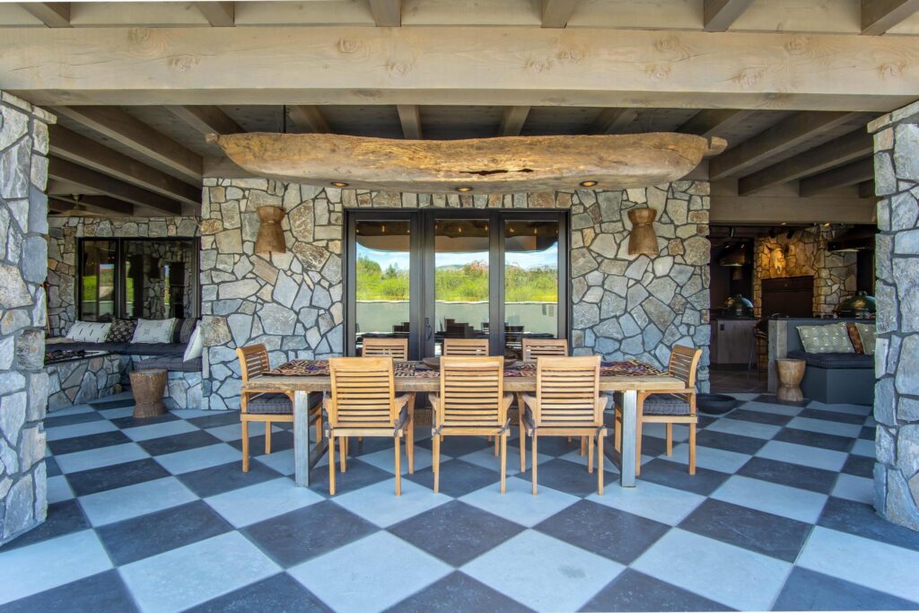 Looking through the pavilion between stone piers to the table and the view