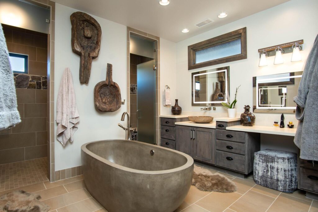 Primary bathroom with the stone tub set against carved pieces on the wall