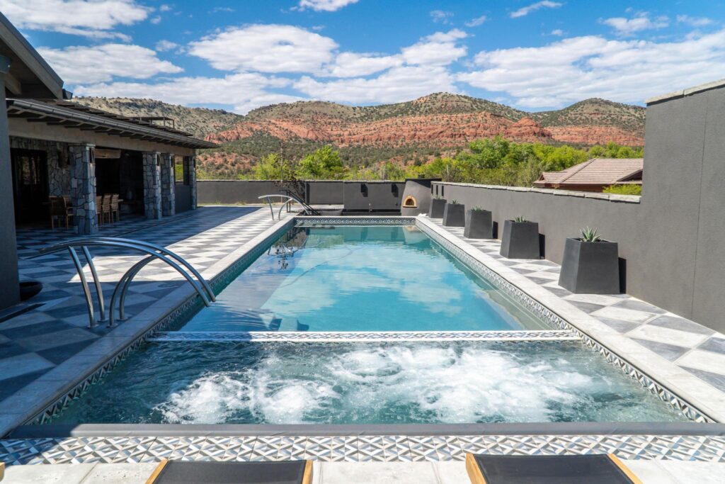 The pool along the terrace, with red rock across the valley