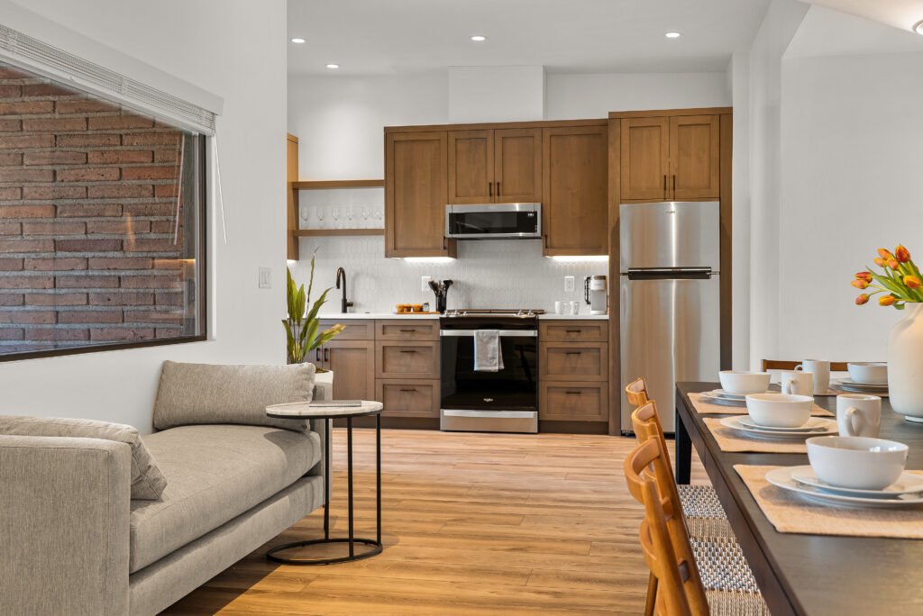 Kitchen and living area at Agave Villas, with a brick wall visible through the window
