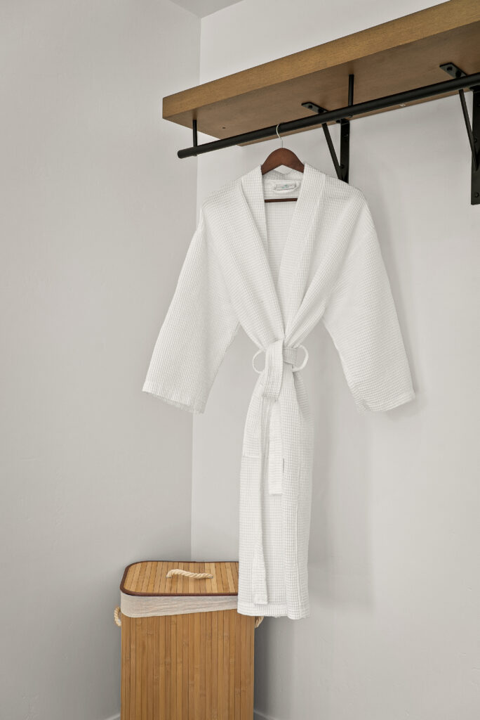 White waffle-weave robe hanging on a hook