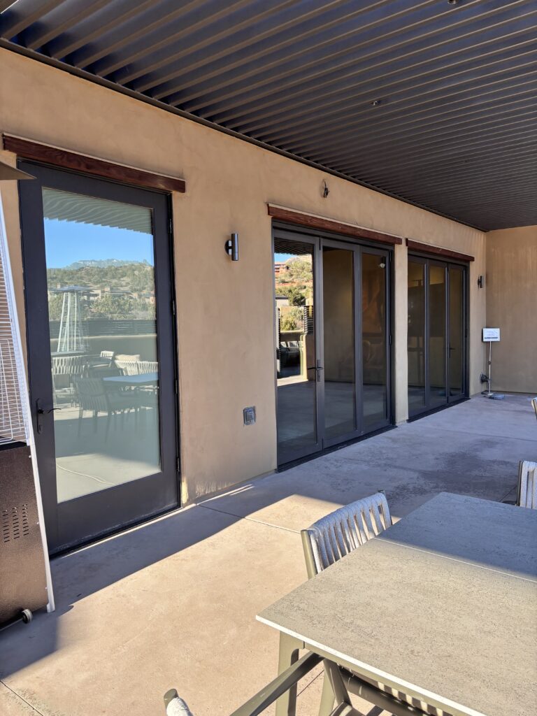 Corner of the clubhouse where the sliding glass walls meet the terrace