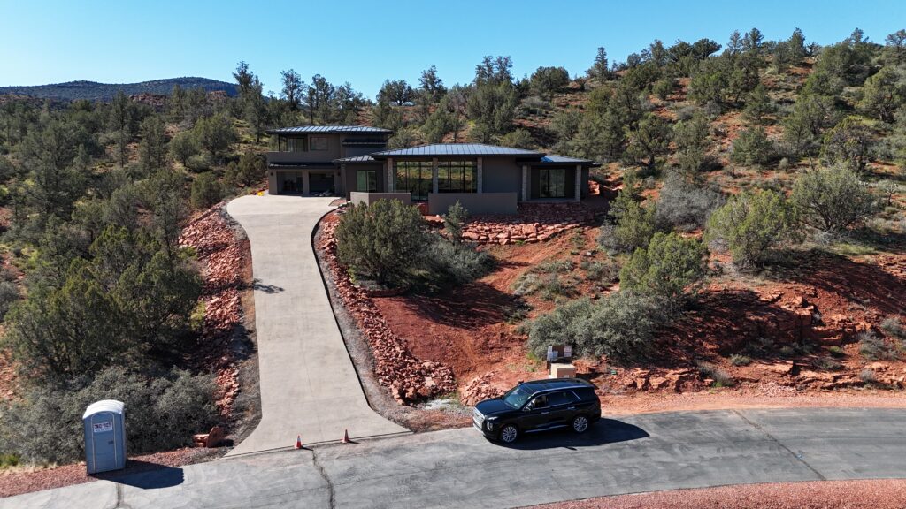 The drive climbing to the house, which sits low against the slope