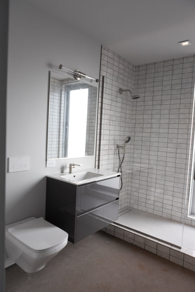 Shower room with a wall-hung basin and a window above