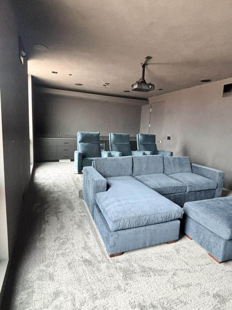 The media room from the back, with a sectional on the lower tier