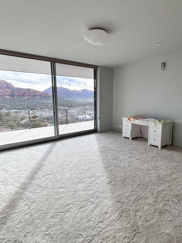 Bedroom opening onto the balcony through a full-height slider