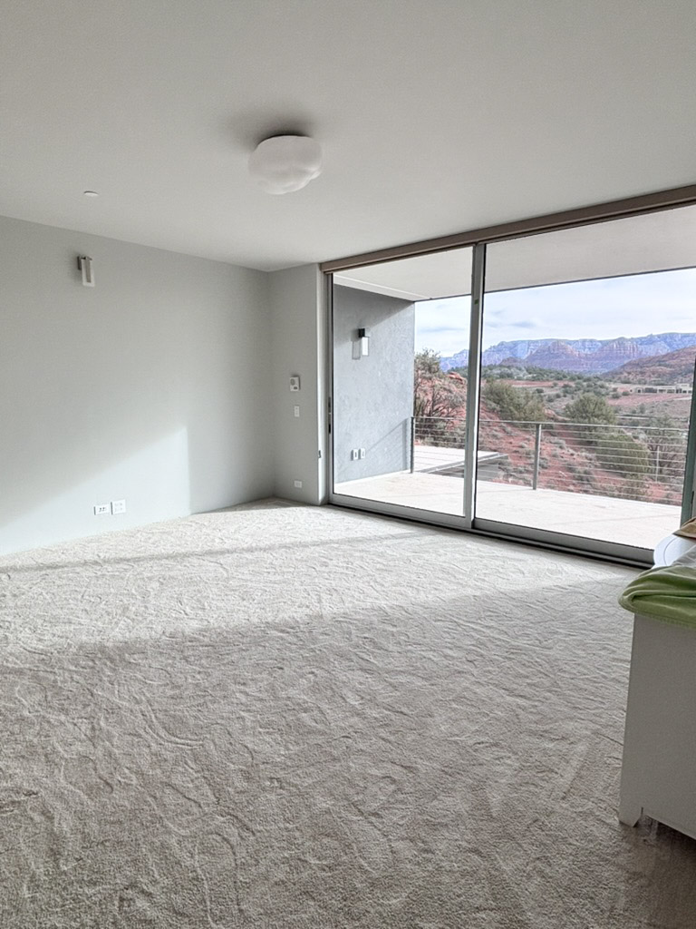 Bedroom with the glazed corner looking out to the rocks
