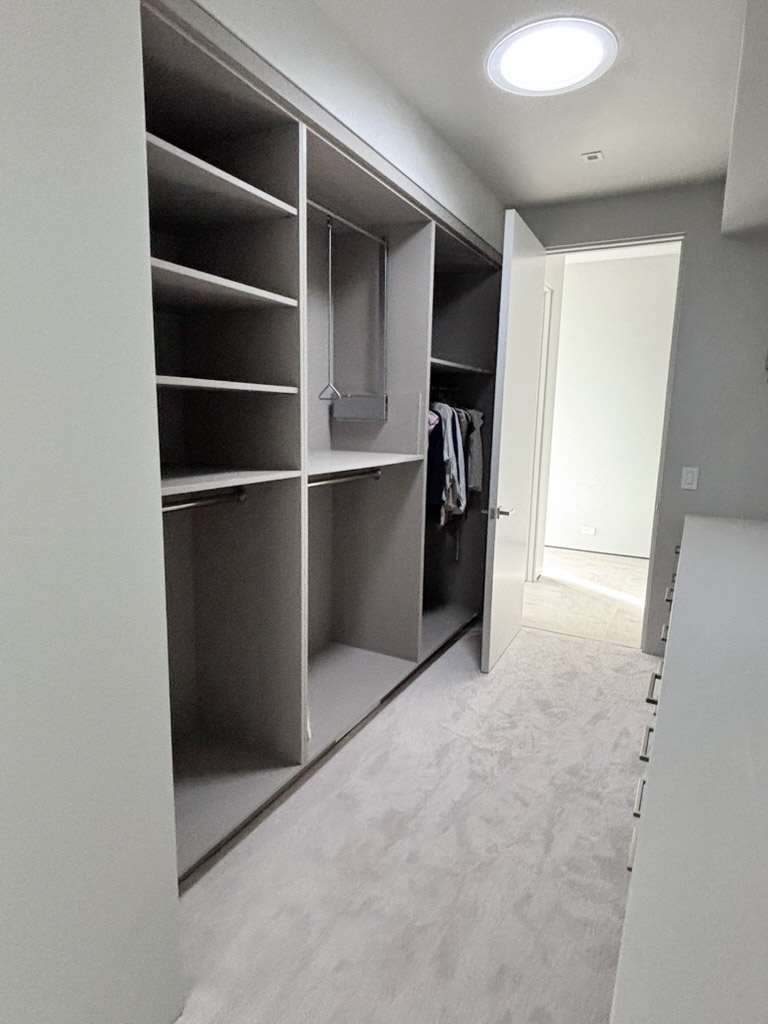 Walk-in wardrobe shelved and railed on both sides