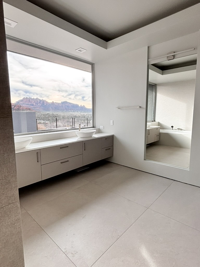 The same bathroom looking back, tub set under the window