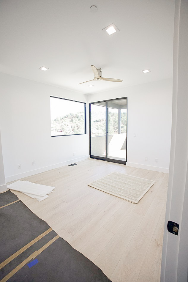 Bedroom with a corner window and a sliding door onto the deck