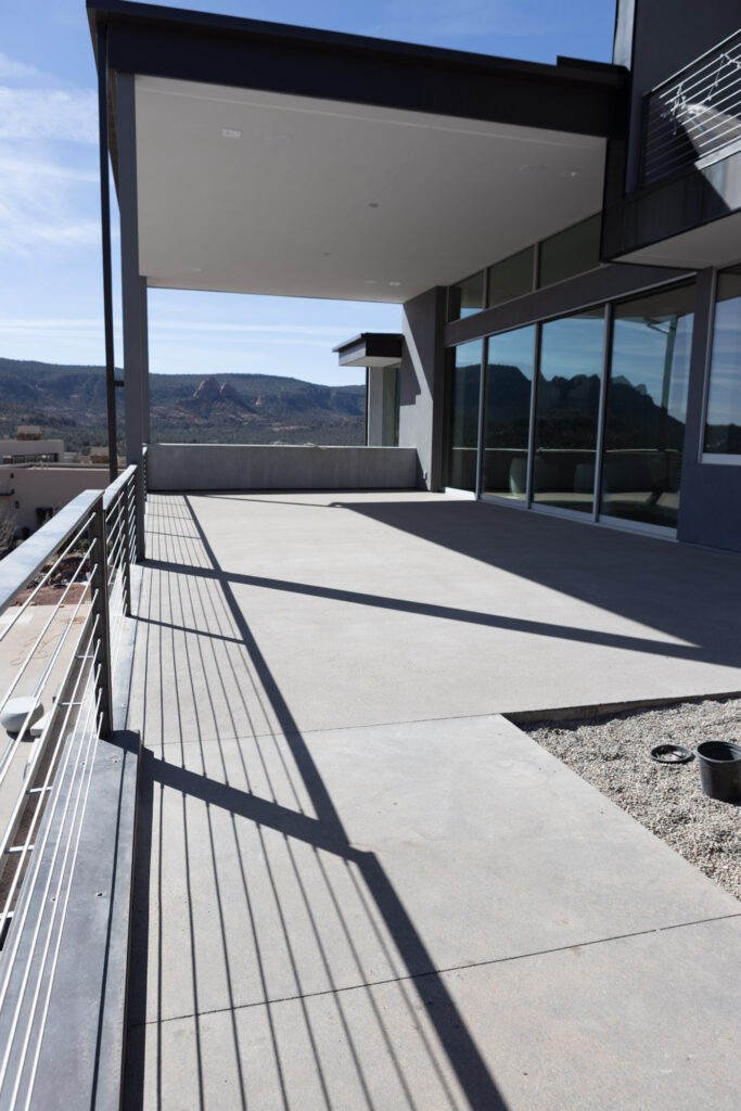 Terrace with cable railing, running along the glazed elevation