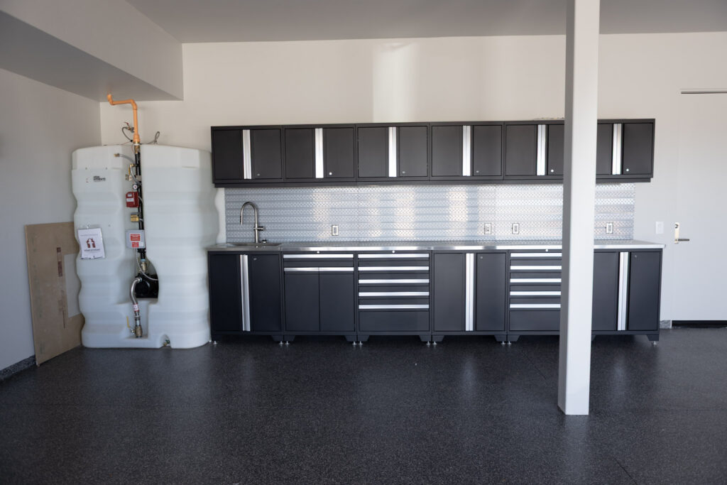 Garage with a full run of cabinets and bench along the back wall