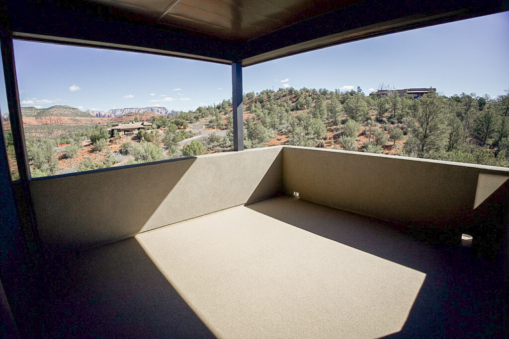 View from the covered deck across the junipers to the red rock horizon