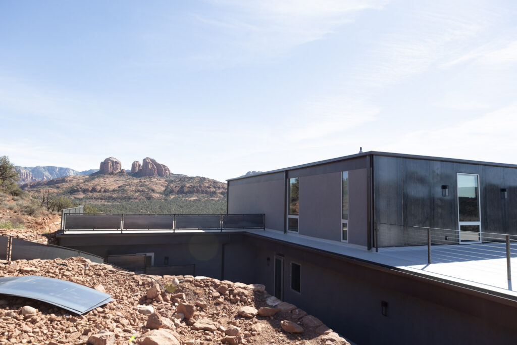 The upper roof and terrace, with red rock formations across the valley