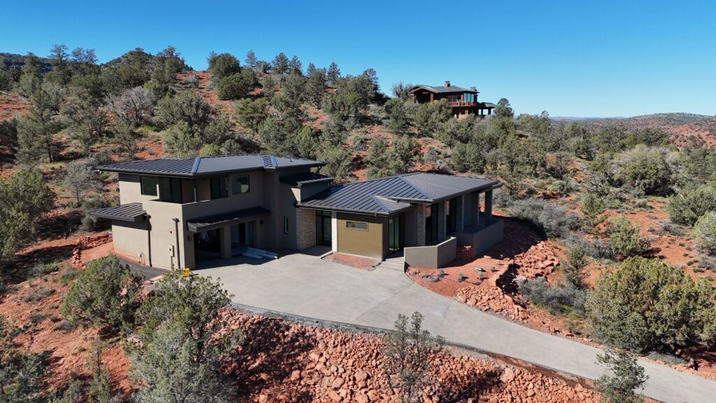 The house from the uphill side, its roofs stepping with the grade