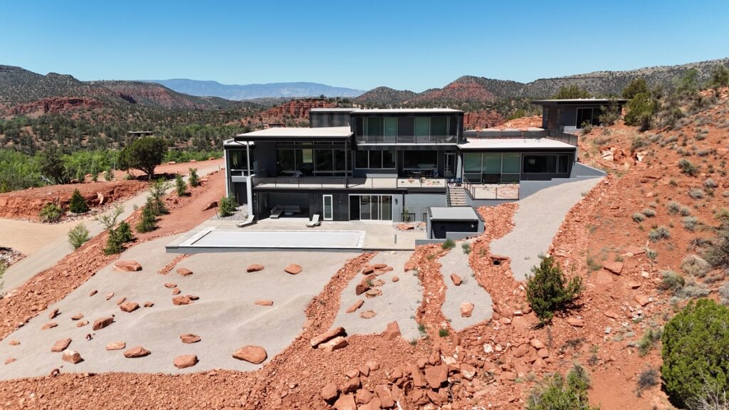 The downhill elevation with the terrace and pool deck in front