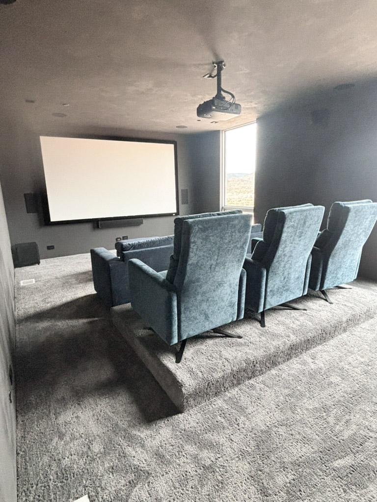 Media room with a projection screen and tiered seating