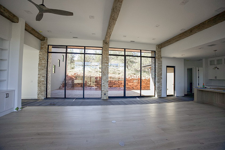 Living area opening through glass doors to the patio and red rock beyond