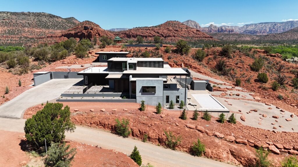 Aerial across the property with the red rock range behind